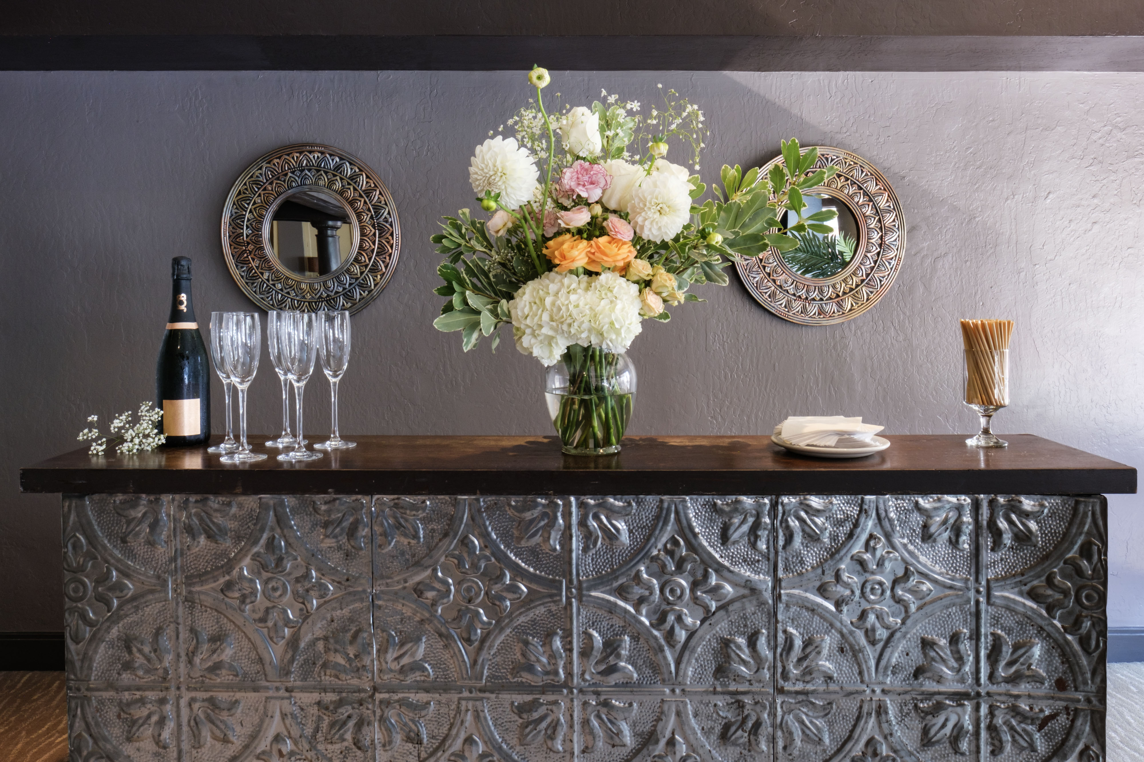 E&O room bar with champagne and floral arrangement