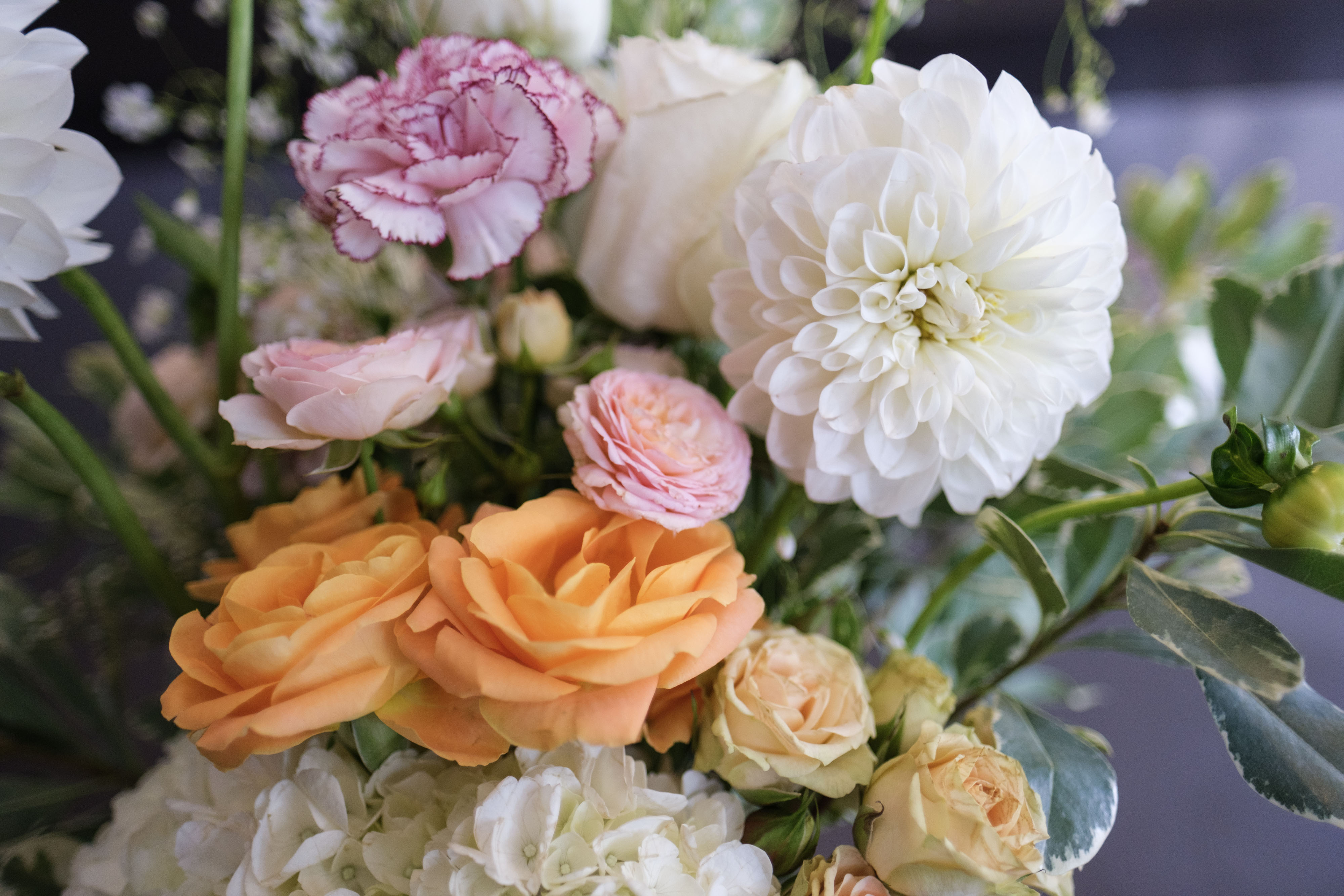 Close-up of blush and orange floral arrangement