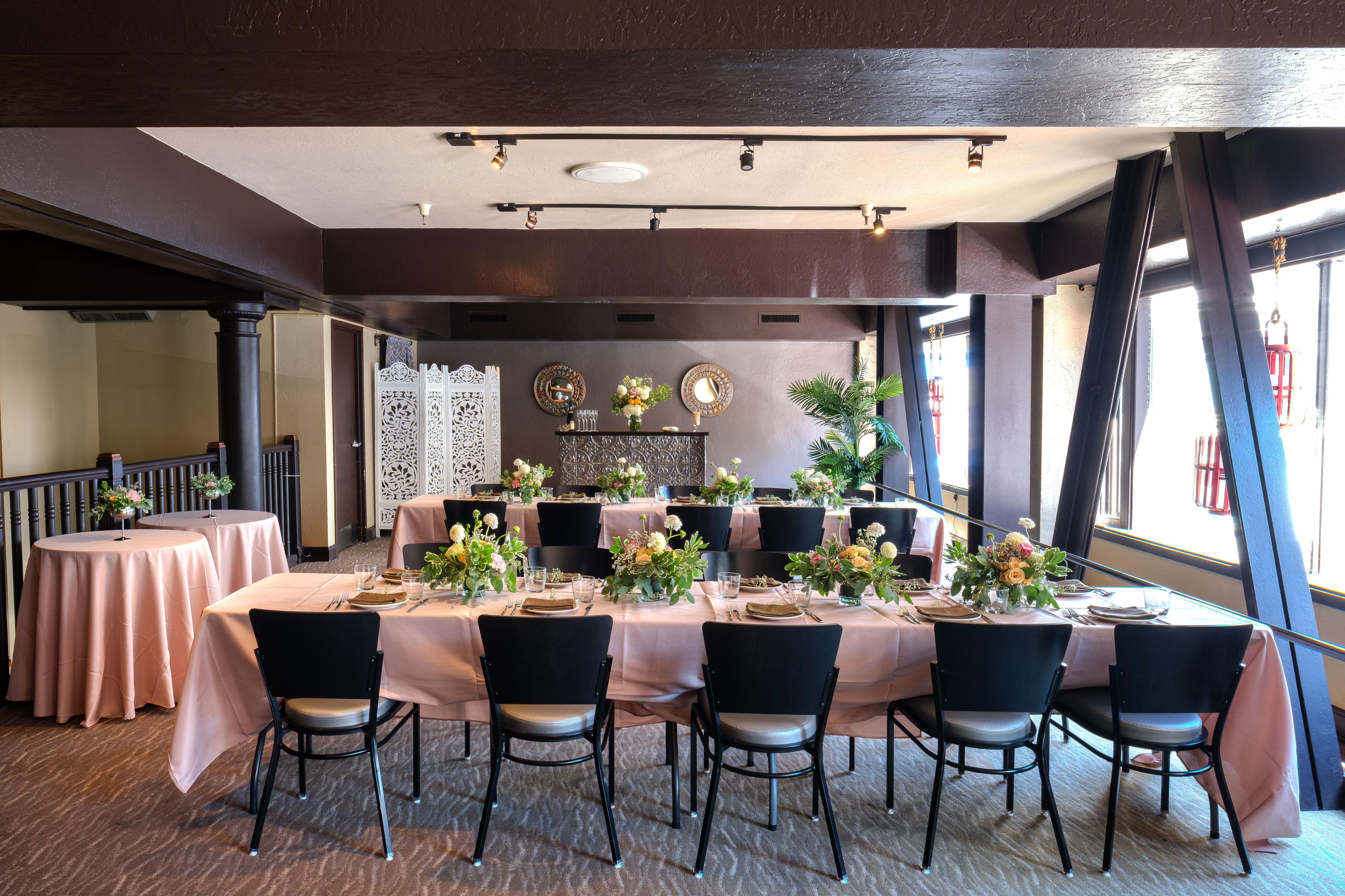 Full E&O room setup with banquet tables and florals