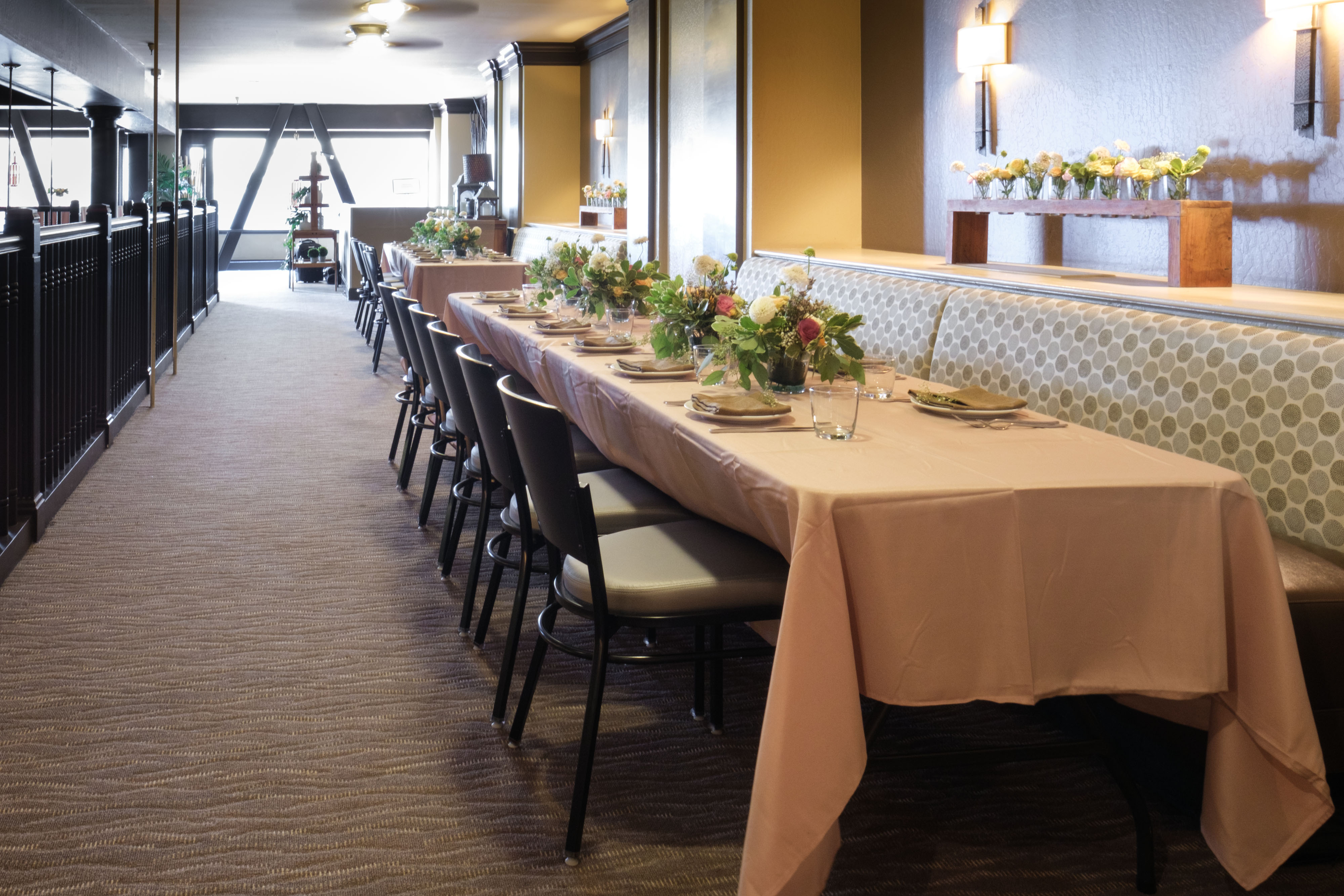 Loge event space with long banquet table and florals